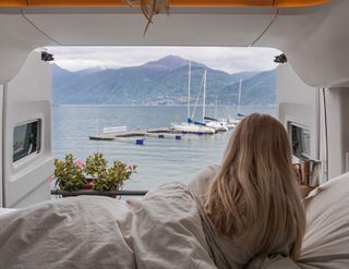 VW Grand California 600 girl in bed with view at lake
